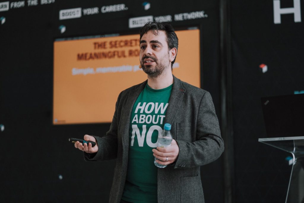Jock Busuttil standing in front of a screen while giving his talk "The Secrets of Meaningful Roadmaps" at Landing Festival 2019 (Photo by Landing Jobs)