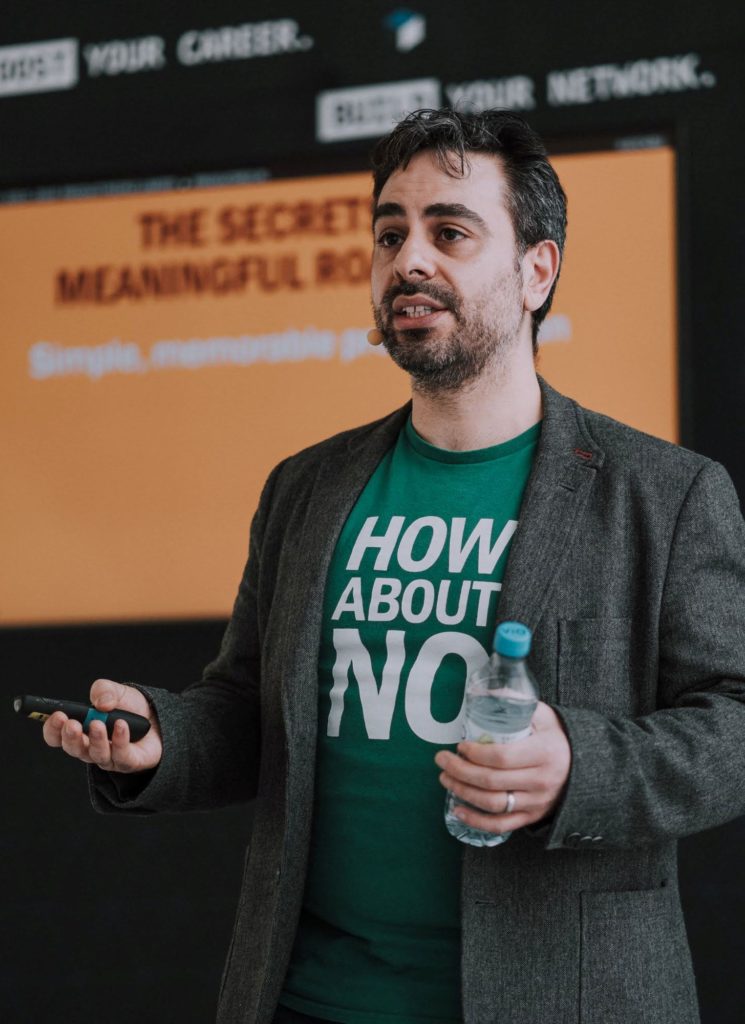 Jock Busuttil standing in front of a screen while giving his talk "The Secrets of Meaningful Roadmaps" at Landing Festival 2019 (Photo by Landing Jobs)