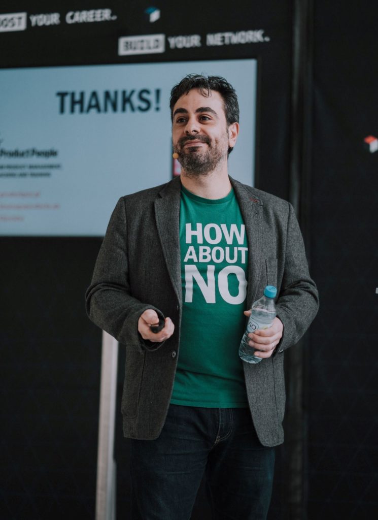 Jock Busuttil standing in front of a screen while giving his talk "The Secrets of Meaningful Roadmaps" at Landing Festival 2019 (Photo by Landing Jobs)