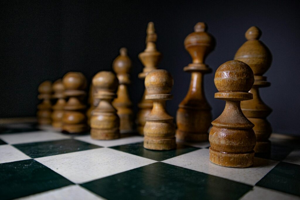 wooden chess pieces on a chess board